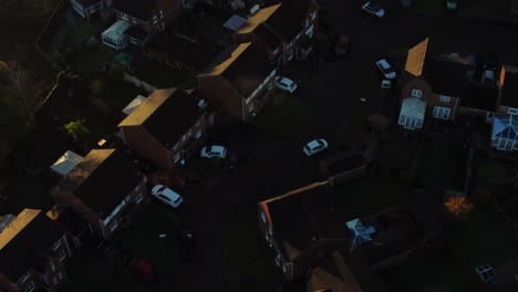 Early-morning-sunrise-Birdseye-over-British-suburban-townhouse-neighbourhood-aerial-view-with-fall-coloured-rooftops