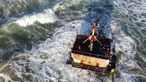 Costa-Rica-beach-drone-view-showing-sea,-shore-and-a-stranded-ship