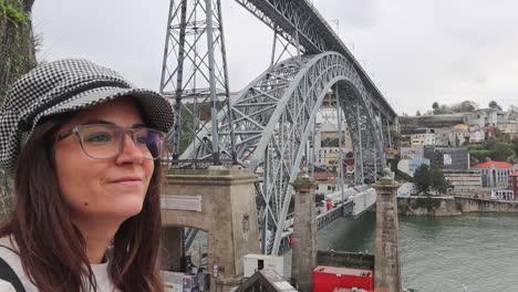 tourist admiring view of city of porto near dom luis i bridge