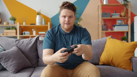 man playing video games on couch