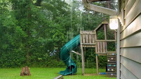 Hochwertiges-Filmmaterial,-Das-Einen-Regnerischen-Tag-Mit-Blick-Auf-Einen-Spielplatz-Im-Hinterhof-Von-Einer-Veranda-Aus-Festhält