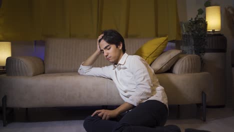 depressed man lying on the sofa.