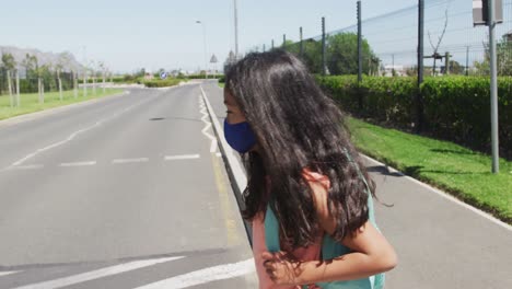 girl wearing face mask crossing the road