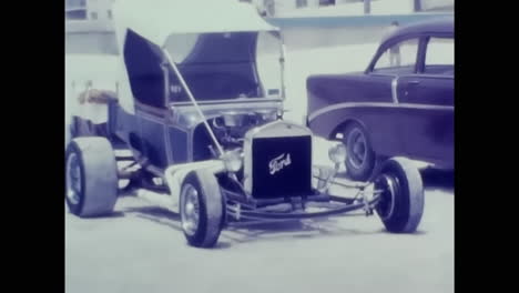 vintage car parked alongside an old car show in 1970s america. circa usa - 1970s: a photograph capturing an old car and a classic car parked side by side in a bustling parking lot during a 1970s car show in the united states..