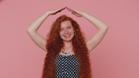 Redhead-woman-playing-childish-catching-up-game,-feeling-in-safe-making-roof-above-head-with-hands