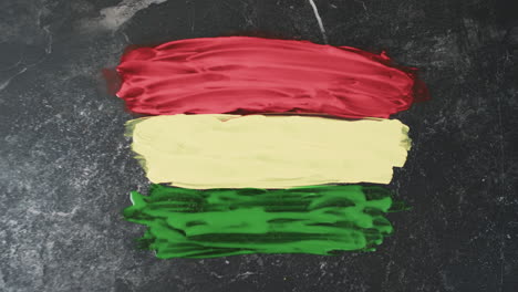 Video-of-red,-yellow-and-green-paint-smudges-with-copy-space-on-black-background