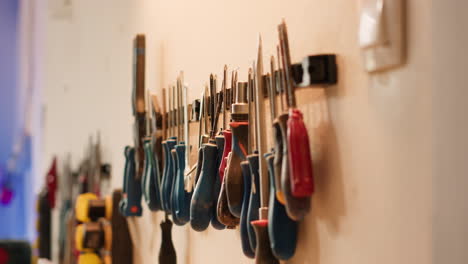 close up of woodworking tools on rack used for carving wood surfaces