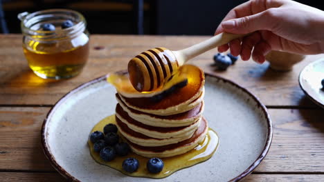 honey drizzled pancakes with blueberries