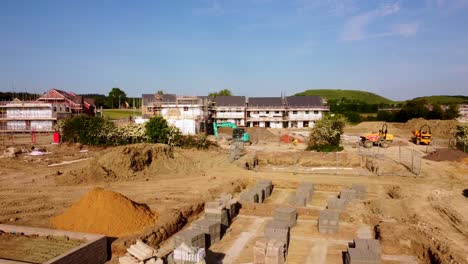 drone shot flying over construction site and new build homes in england