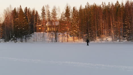 Person-going-back-home-to-forest-cabin-during-winter-season