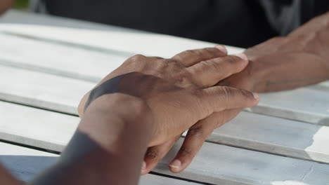 Close-up-shot-of-gay-couple's-hands-touching-each-other-with-tenderness