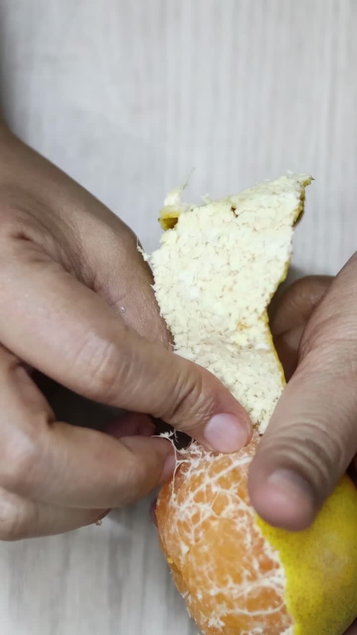 Sequential frames showing the peeling of an orange