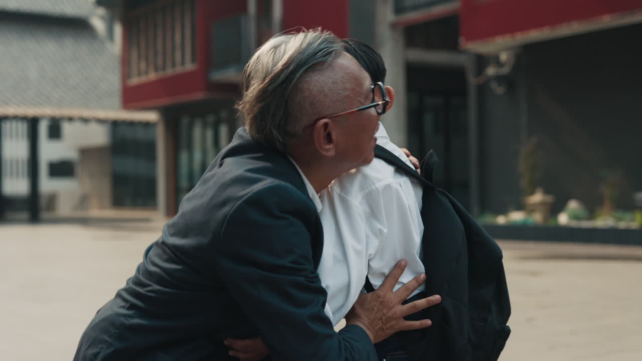 A grandfather saying goodbye to his grandson as he goes to school