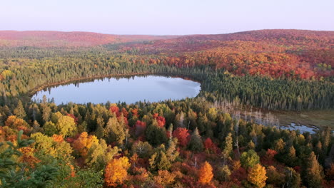 small rural lake surrounded by breathtaking fall foliage