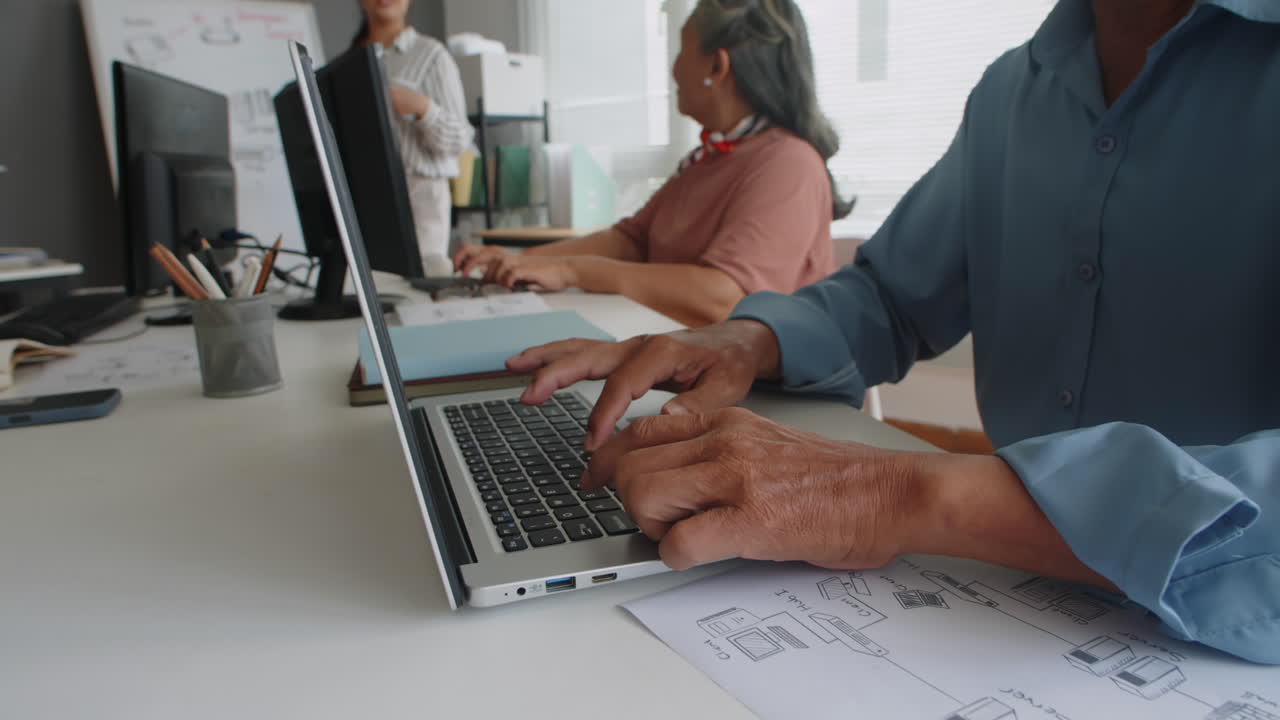 Pensioners Typing Text on Keyboard during Computer Class