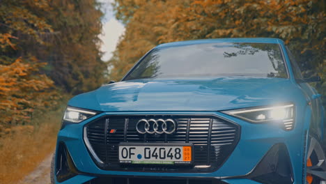 presentation of a blue audi e-tron, compact luxury crossover suv. modern new cars for sale