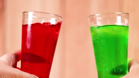 red and green drinks clinking in celebration