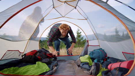 hikers lying down in tent after hike in mountains