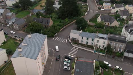 drone hovers, tracks car in french suburb scenic drive