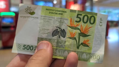 close up of 500 cfp franc currency money note in tahiti, french polynesia