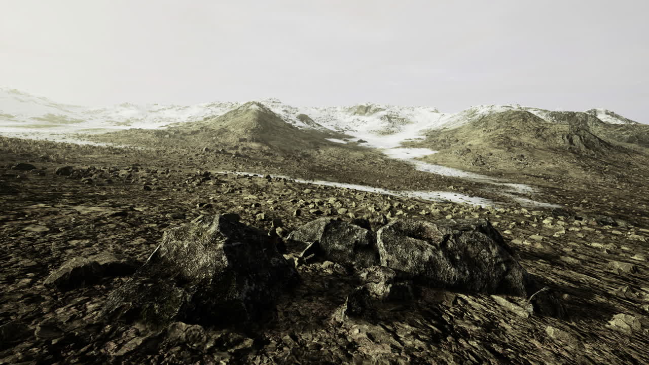 Vast rocky landscape with gentle slopes under a muted sky at dawn