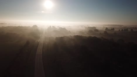aerial shot rising through thick fog in the missouri ozarks