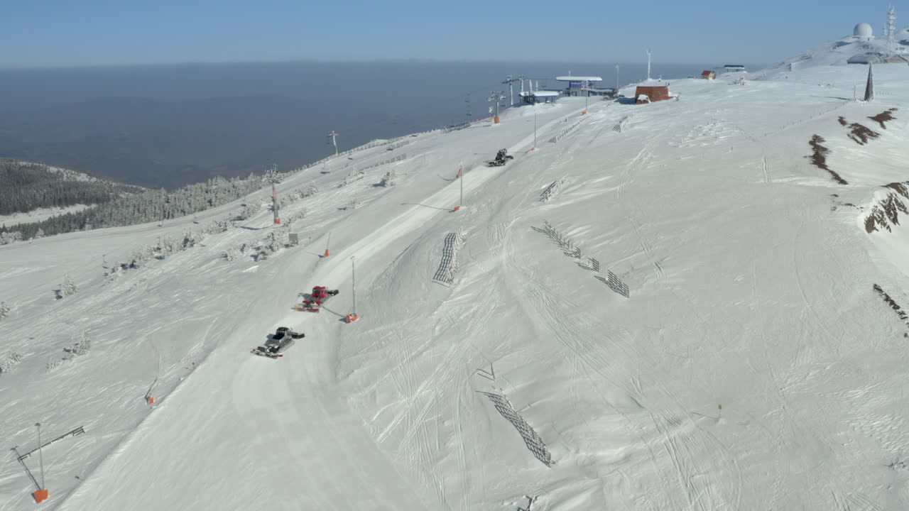 Aerial View of Snow Groomers Preparing Ski Slopes on a Mountain Resort