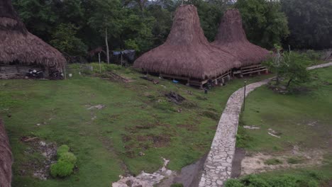 Local-man-walks-in-traditional-village-at-Sumba-Indonesia,-aerial