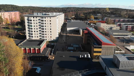 Aerial-flyover-residential-area-of-Bergsjön-District-in-Gothenburg-during-sunny-day-and-forest-landscape-in-background