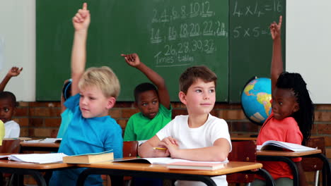 pupils listening and raising their hands during class