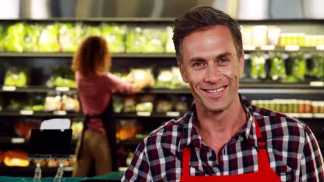 portrait of smiling male staff showing ok handsign in organic section