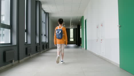 Schoolboy-walking-through-the-corridor.