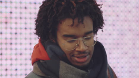 portrait of a man wearing glasses and scarf