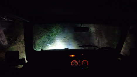 pov jeep driving up a bumpy track at night time