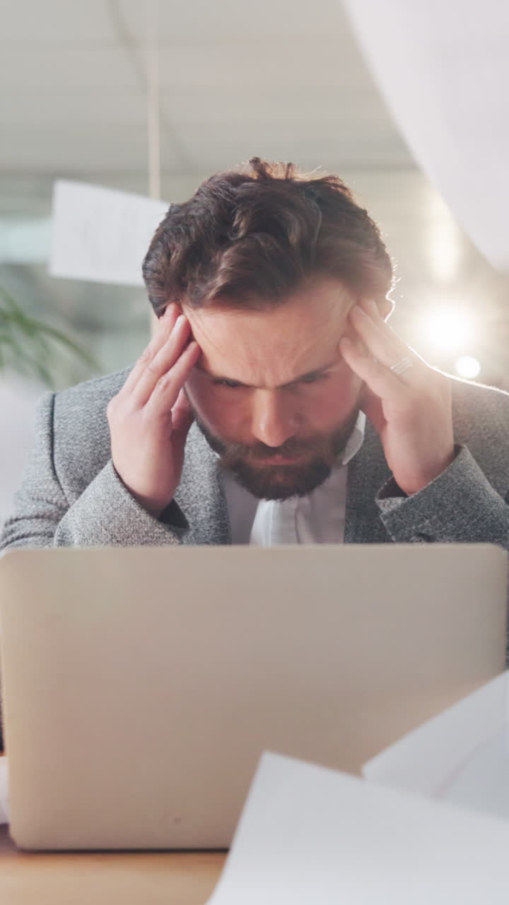 Stressed Businessman Overwhelmed by Falling Papers in Office