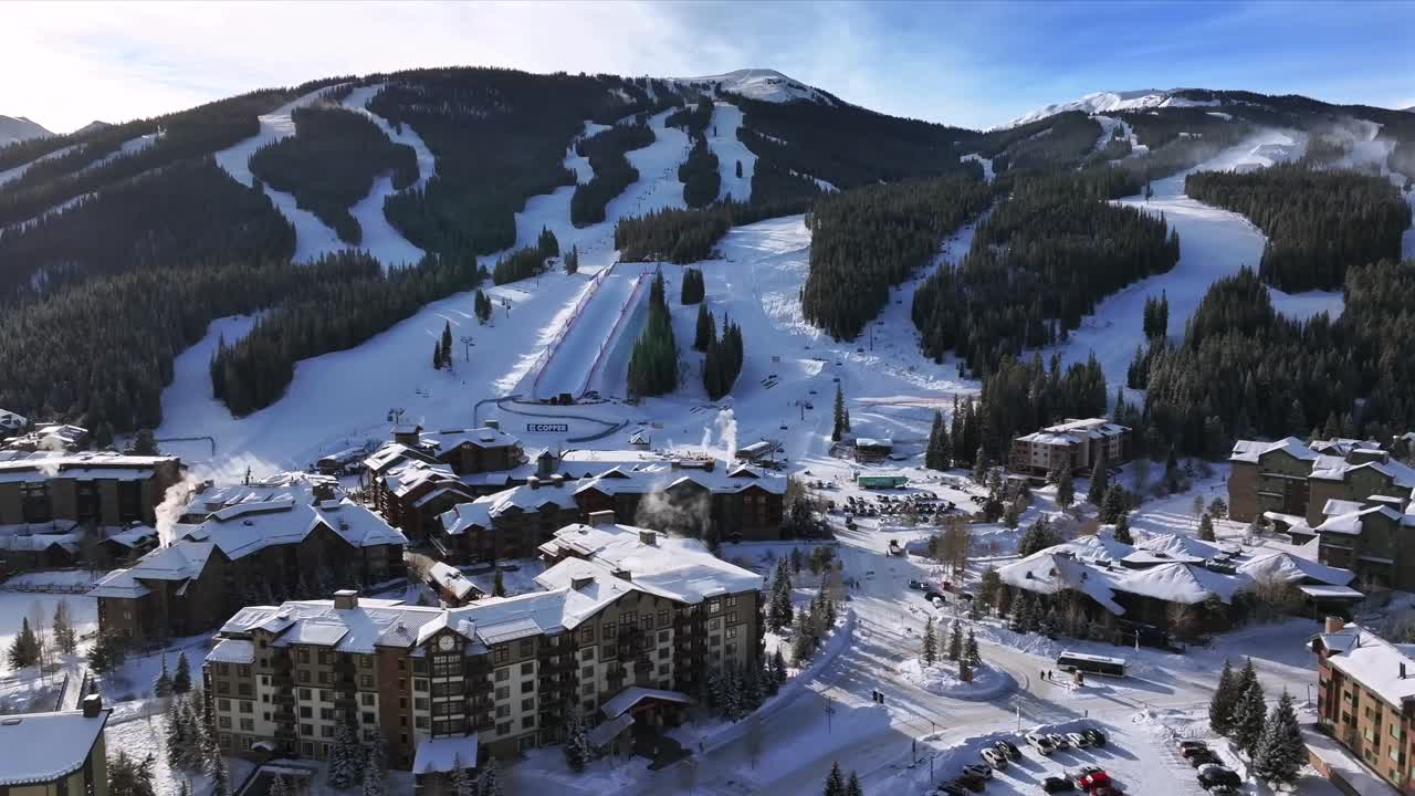 Morning winter solstice Center village Copper Mountain Resort aerial drone chairlifts gondola Ikon Pass Alterra snowboarding snow ski riding trails December halfpipe snow guns trees circle right