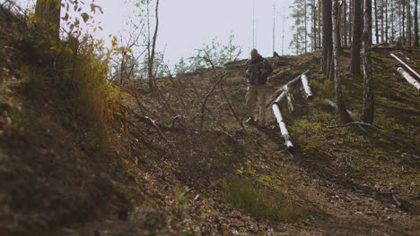 aged man mushroomer is lost in forest walking alone and looking for exit extreme hiking and backpacking by himself