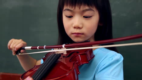 cute pupil playing violin