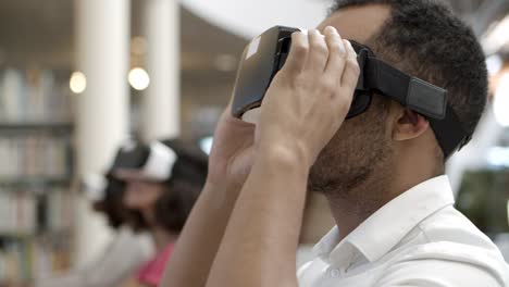 closeup shot of smiling young man wearing virtual reality glasses