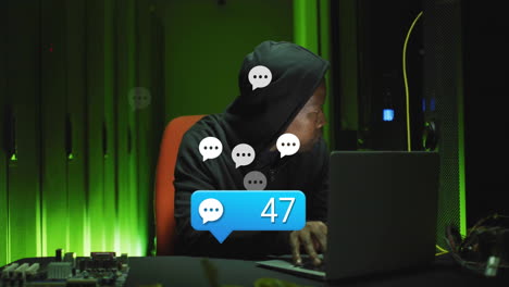 using laptop in dark room, person in hoodie receiving chat notifications