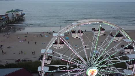 flying past a ferris wheel towards the ocean at old orchard beach in maine