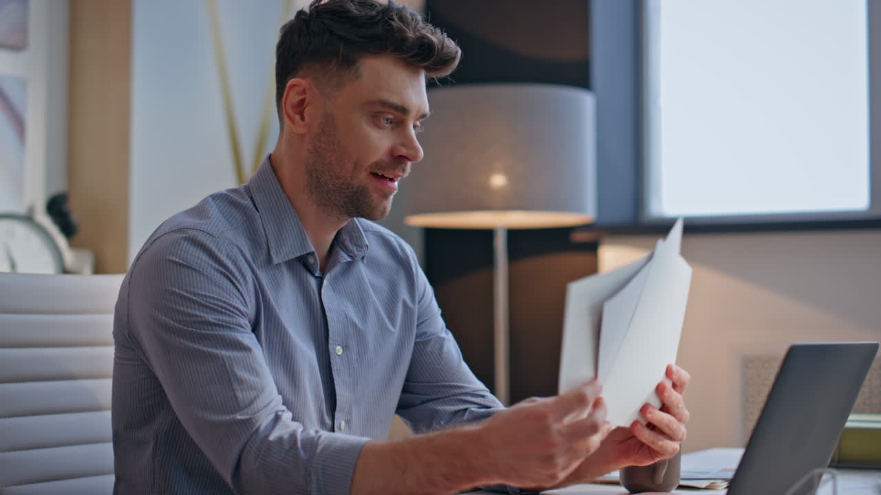 Inspired creator watching sketches at modern workplace closeup. Designer working