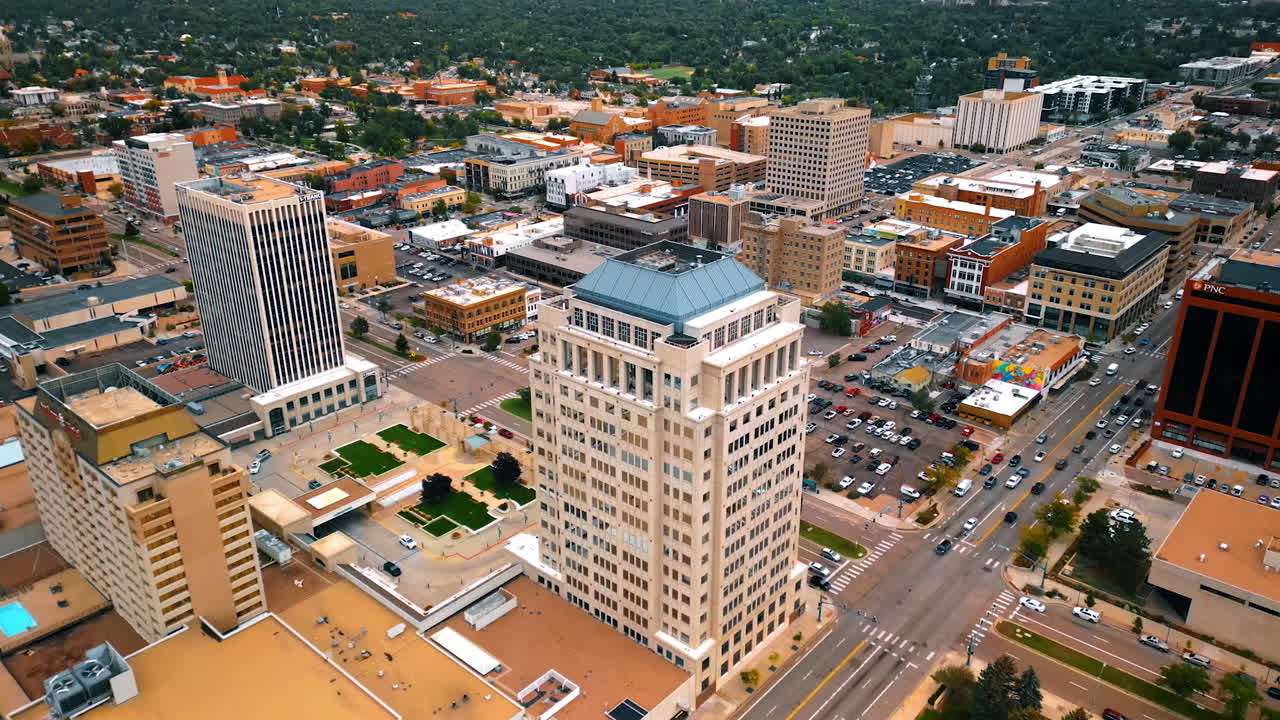 Colorado Springs, USA, 22 July 2025: Rising over the downtown of Colorado Springs, Colorado, USA with multiple parking lots. View on the vast scenery of the city in lush greenery at outskirts