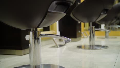 three hair salon chairs and mirrors