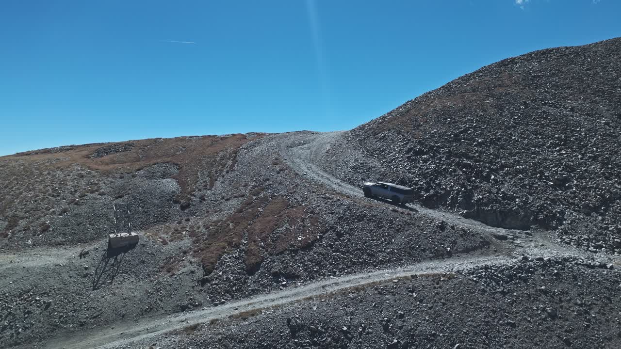 Aerial dolly to truck navigating steep switchbacks along the Peak 10 trail Breckenridge Colorado