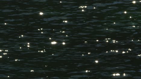 cinematic closeup shot of ocean waves sparkling with the sunlight