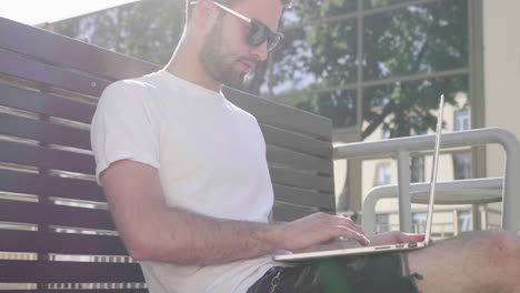 man working on laptop outdoors