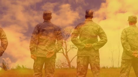 Animation-of-soldiers-standing-and-looking-up-with-orange-clouds-moving-in-fast-motion.