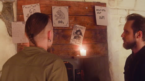 two friends looking at old papers hanging on a wall