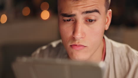 close-up of a man looking at a tablet